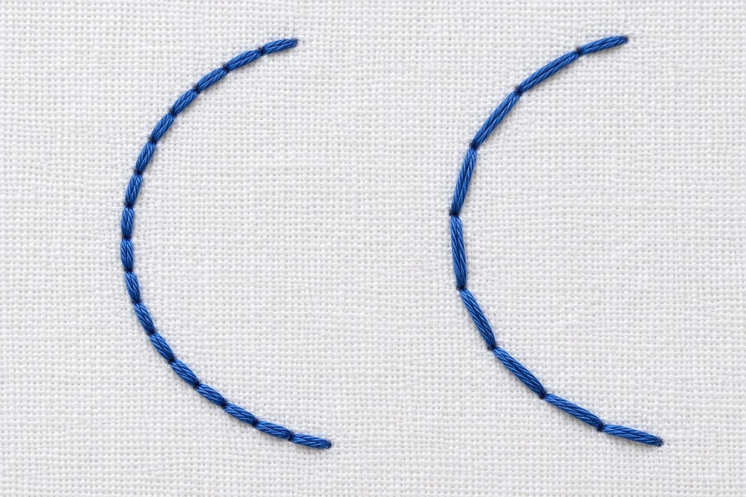 Two blue backstitched curves comparing short connected segments with longer angular segments