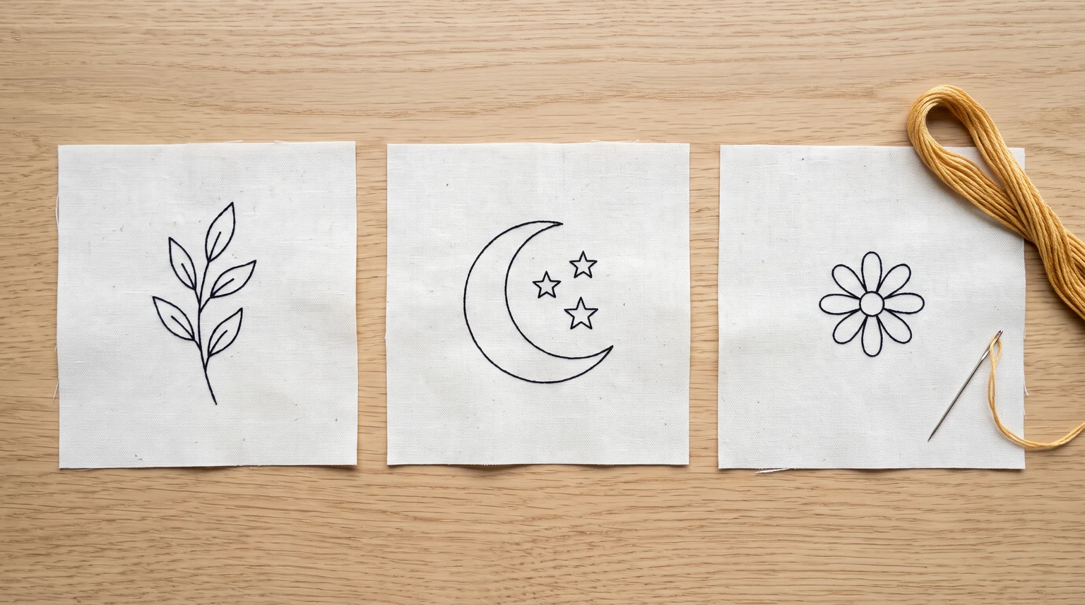 Three simple line drawings of a sprig, crescent with stars and small flower
