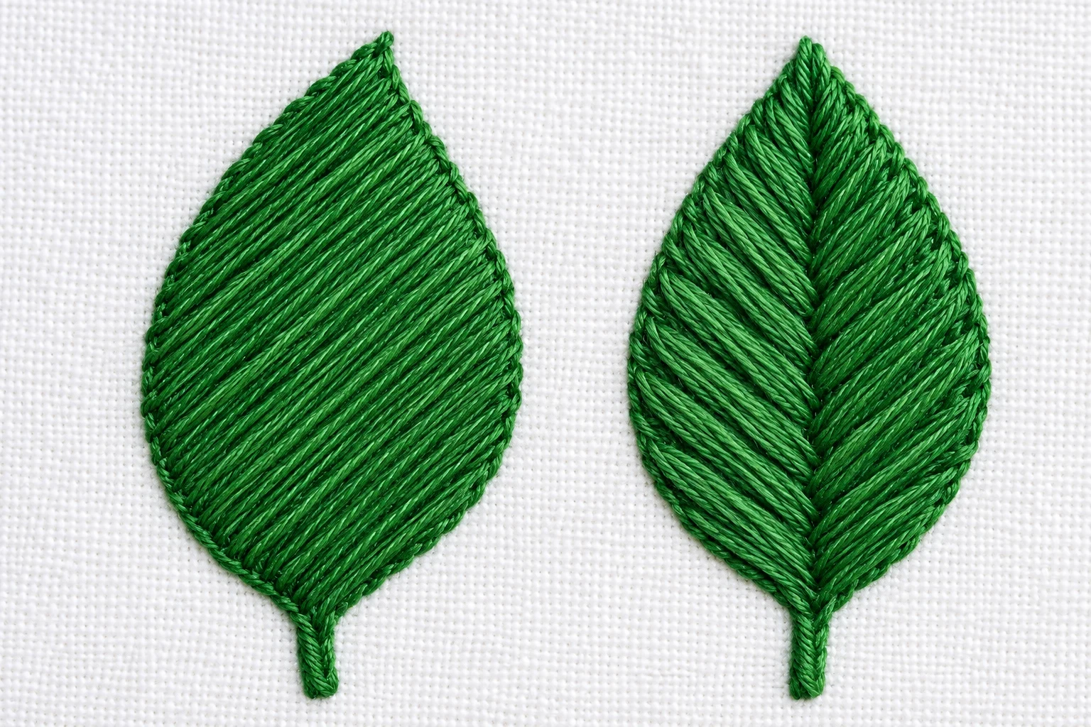 Green leaves comparing uninterrupted parallel diagonal satin stitches with a central fishbone vein