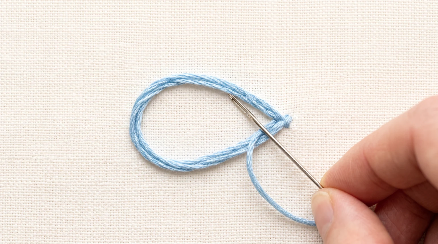 Close view of a pale blue loop petal with a needle at its outer tip