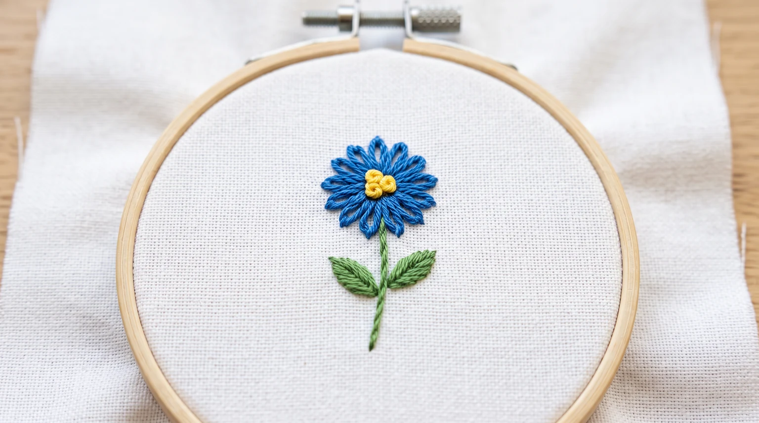 Single blue loop-petal flower with yellow center and green stem and leaves