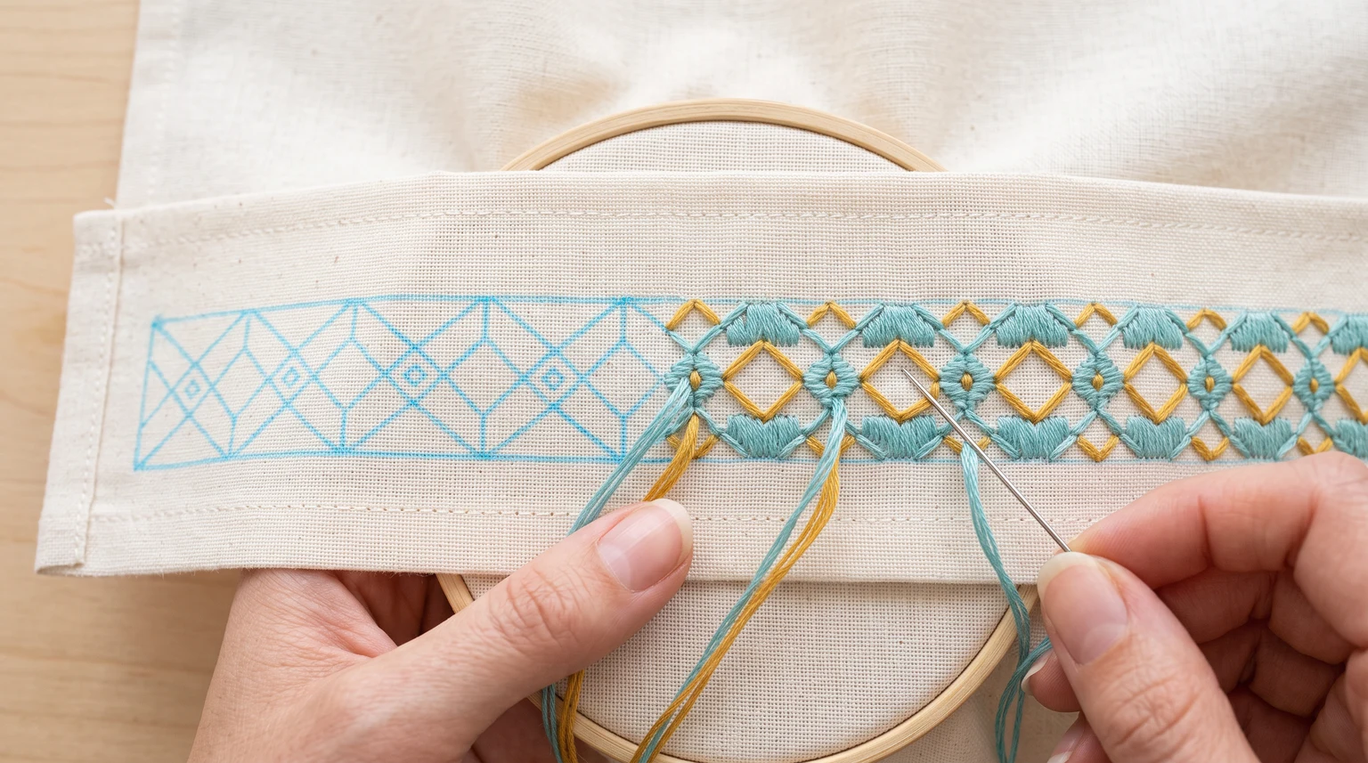 Partly stitched geometric border in gold and teal beside the remaining blue repeat outline
